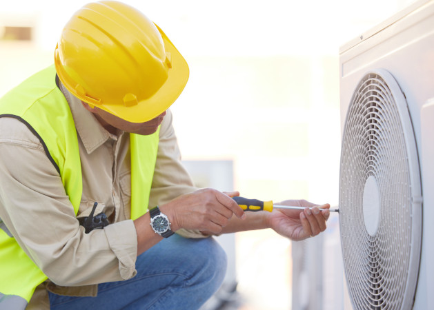 Air conditioning, technician or engineer on roof for maintenance, building or construction of fan h.