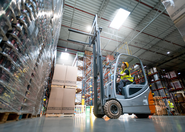 Warehouse worker operates a forklift